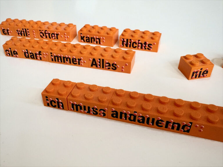 Legobausteine seitlich mit Schwarzschrift und Braille bedruckt